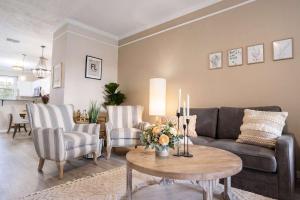 a living room with a couch and chairs and a table at Stylish Sanctuary King Beds Upscale Condo in Gainesville