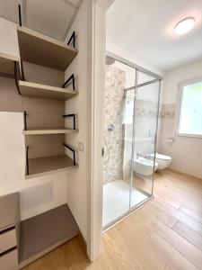 a bathroom with a walk in shower and a toilet at Panoramic and view apartments in Lezzeno +26 photos