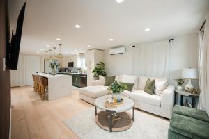 a living room with a white couch and a table at Coastal Sands Inn in Wildwood