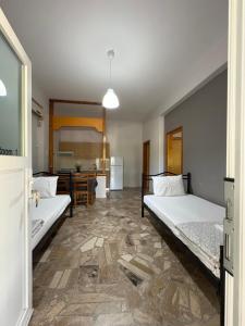a room with two beds and a kitchen with a table at Villa Maria in Ofrínion