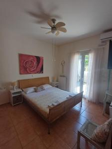 a bedroom with a bed and a ceiling fan at Verdalia Private Holiday House in Stavrákia