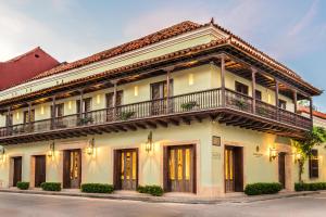 a white building with a balcony on top of it at Hotel Capellán de Getsemaní in Cartagena de Indias