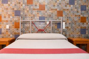 a bed with a pair of scissors on top of it at Hotel Posada el Cid in Oaxaca City +51 photos