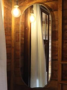a mirror on a wall with a curtain and lights at Chill and Surf Mendihuaca in Santa Marta +62 photos