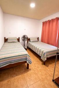 two beds sitting next to each other in a room at Brisas Griegas in Quepos +28 photos