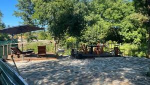 a patio with a table and an umbrella at Къща за гости Зеленец in Sozopol