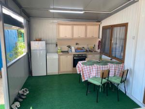 a small kitchen with a table and chairs in it at Къща за гости Зеленец in Sozopol +17 photos