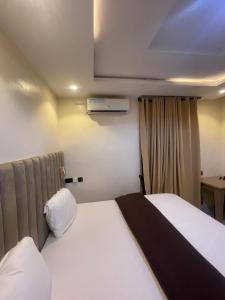 a hotel room with two beds and a window at CHASE hotels in Ibadan