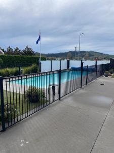 a black fence next to a swimming pool at # 2 Ald in Cambridge