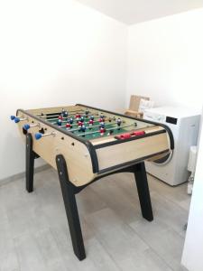 a foosball table with avertisement for at L' Eminence in Clécy