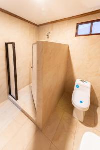 a bathroom with a toilet and a shower at Hotel Castillo in San José +50 photos