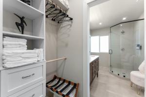 a bathroom with a walk in shower and white towels at Charming house in Midtown District in Reno +52 photos