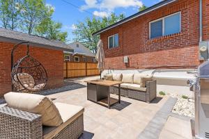 a patio with a couch and a table and a tub at Charming house in Midtown District in Reno