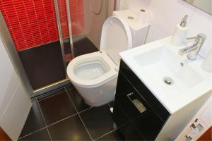 a small bathroom with a toilet and a sink at Casa do Castelo - Calm & lovely 2-bedroom Apt Near the Beach in Sesimbra +22 photos