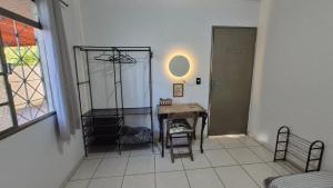 a room with a table and chairs and a window at Casa Pitanga Quarto in Barra do Garças