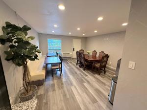 a dining room and living room with a table and chairs at Cedarwood Inn of Ashland in Ashland