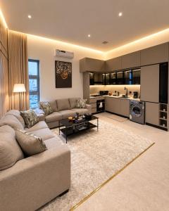 a large living room with a couch and a kitchen at مساكن لينا الفندقية in Abha