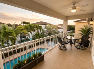 a balcony with a table and chairs and a pool at The Oasis, Miami Lakes in Miami Lakes
