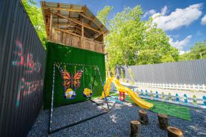 a play area with a swing and a fence at Bungalov Azerbaijan in Vǝndam
