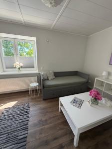 a living room with a couch and a table at Otepää city view apartment in Otepää