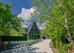a building with a pointed roof and a walkway at Bungalov Azerbaijan in Vǝndam