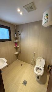 a bathroom with a toilet and a sink at Pearl sea in Al Jubail +17 photos