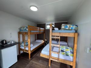 a room with three bunk beds in a house at Cambridge Top 10 Holiday Park in Cambridge +87 photos