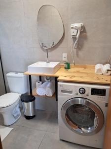 a bathroom with a washing machine and a mirror at Casa VNE 01 in Araranguá +17 photos