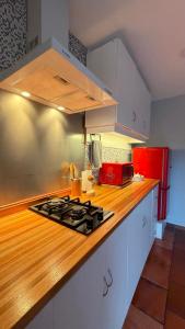 a kitchen with a stove and a counter top at Viento Azul Guest House in Punta del Este