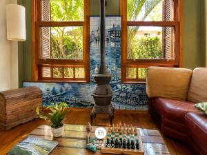 a living room with a chess board and windows at Bollté Praia Boutique Pousada - Campeche - Floripa - SC in Florianópolis +128 photos