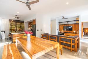 a living room with a wooden table and chairs at Private Jungle House No1Calalu with AC, Pool & EV in Talamanca