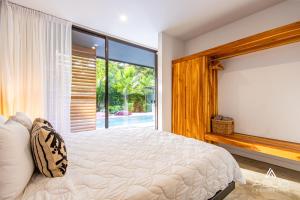 a bedroom with a bed and a large window at Private Jungle House No1Calalu with AC, Pool & EV in Talamanca +43 photos