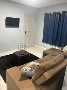 a living room with a couch and a flat screen tv at Casa completa bem equipada ótima localização in Joinville
