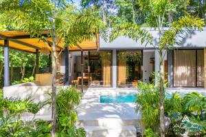 a house with a swimming pool and trees at Private Jungle House No1Calalu with AC, Pool & EV in Talamanca