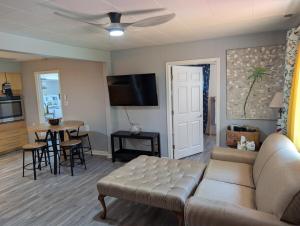 a living room with a couch and a table at Otterspace at the beach in Shady Side