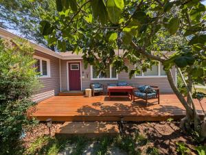 a wooden deck with a table and chairs on a house at Otterspace at the beach in Shady Side