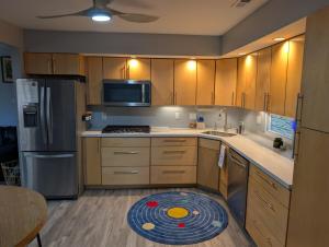 a kitchen with wooden cabinets and a frisbee on the floor at Otterspace at the beach in Shady Side