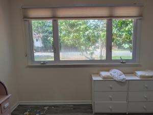a window in a room with a dresser and a dresser with a window at Otterspace at the beach in Shady Side +26 photos