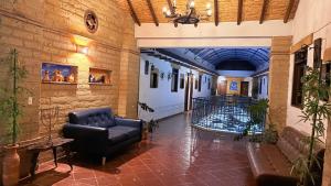 a lobby with a couch and a fish tank in a building at Hotel Villa Encanto in Villa de Leyva
