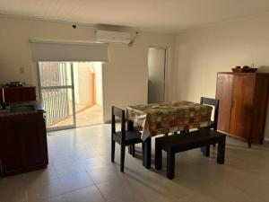 a dining room with a table and chairs in a room at 9 De Julio in Charata