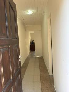 an empty hallway with a wooden door and a hallway at 9 De Julio in Charata +1 photo