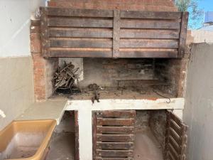a dirty room with a fireplace and a sink at 9 De Julio in Charata