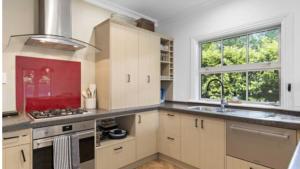 a kitchen with a sink and a stove top oven at Wood Street Haven in Greytown