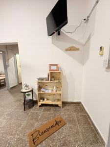 a living room with a television on the wall at Villa Valeria in General Acha