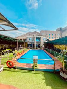 a large swimming pool in front of a building at Lexworld Hotels in Aba