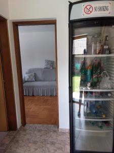 a refrigerator with a no smoking sign next to a living room at Villa Valinor in Slatina Varoš
