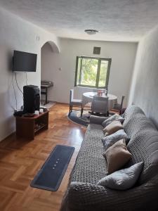 a living room with a couch and a table at Villa Valinor in Slatina Varoš