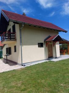 a small white house with a red roof at Villa Valinor in Slatina Varoš