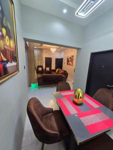 a dining room with a table with a pumpkin on it at O2 Continental Suites in Kubwa