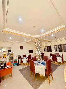 a dining room with a table and chairs at Lexworld Hotels in Aba